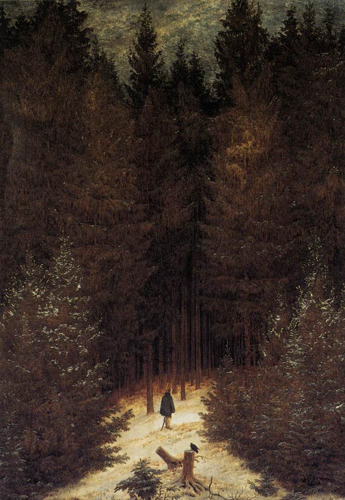 A lone hunter is seen among tall, dark trees in a winter landscape.