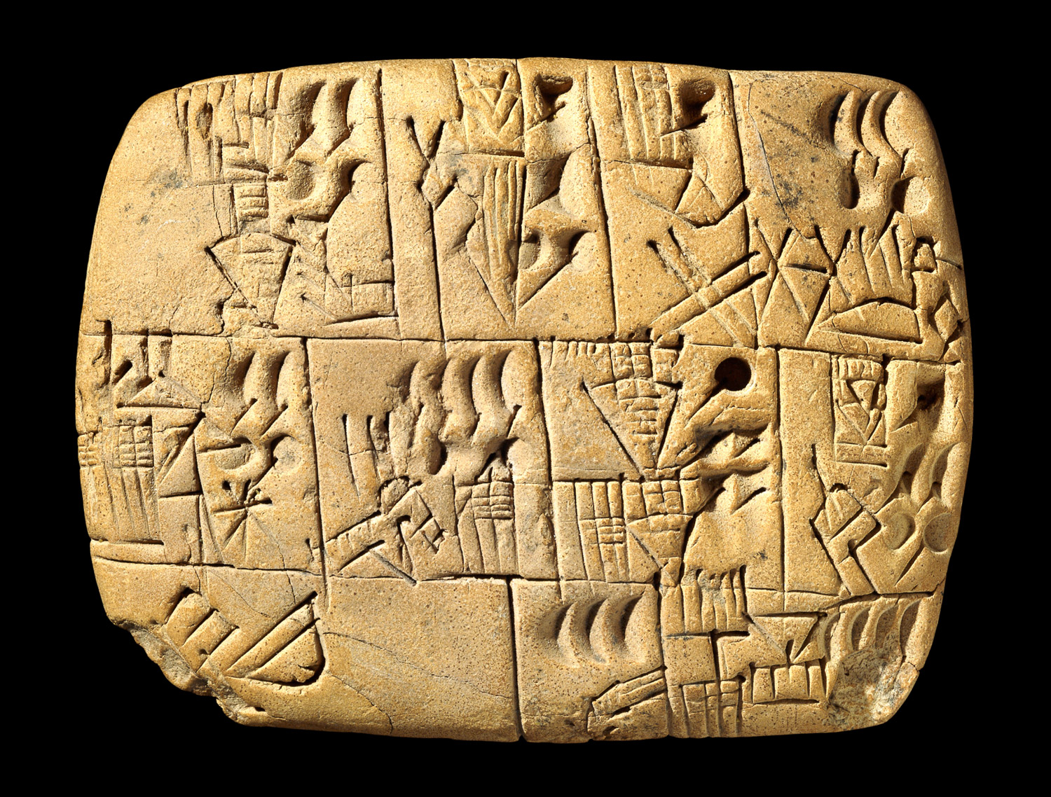 Rounded clay tablet on black ground with cuneiform signs.