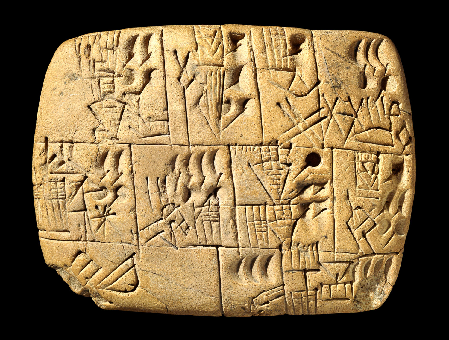 Rounded clay tablet on black ground with cuneiform signs.
